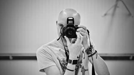 Young man with dslr cameraのeditorial素材