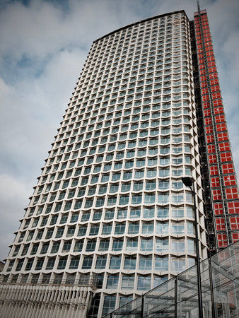 Long skyscraper with red windows in London Town Centre.