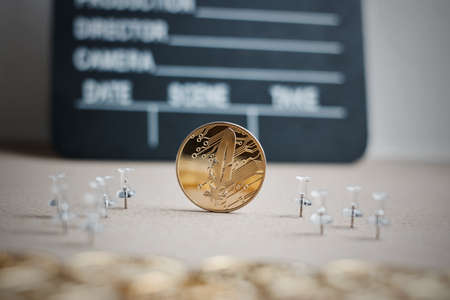 Digital currency physical gold feather coin. Cinema cryptocurrency concept.の写真素材