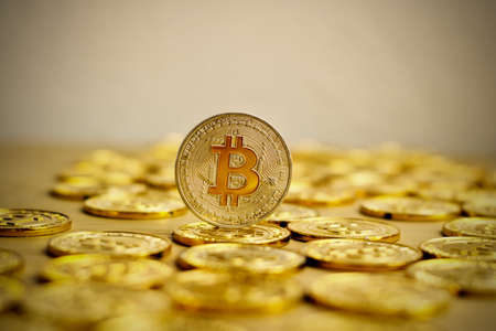 Digital currency physical bitcoin coin. Gold background coins concept.の写真素材