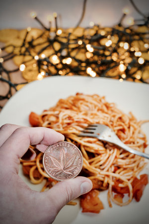 Brass marijuana coin with leaf. Italian pasta food concept.の写真素材