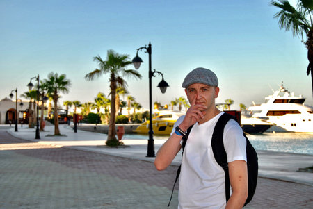 White young man on holiday in Egypt. Palm tree, boats, sun and relax time.の写真素材