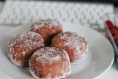 Delicious doughnuts on the white plate. Sweet fresh food concept.の写真素材