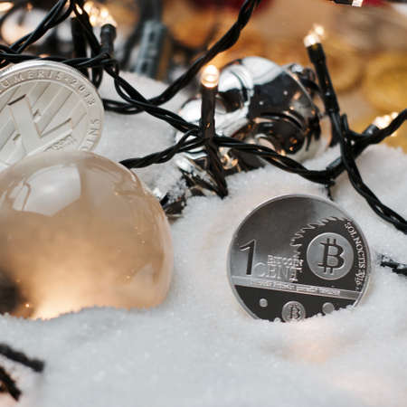 Digital currency physical metal bitcoin coin. Crypto currency christmas snow composition.の写真素材