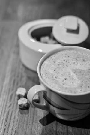 Fresh and tasty coffee in the kitchen on the wooden board. Drink concept.の写真素材