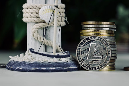 Digital currency physical silver Litecoin coin. Cryptocurrency concept.