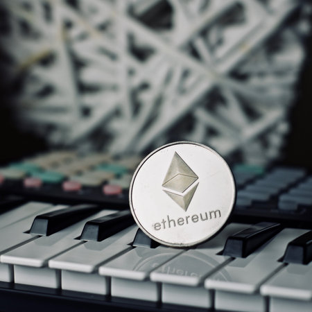 Digital currency physical metal ethereum coin and music keyboard. Cryptocurrency audio concept.