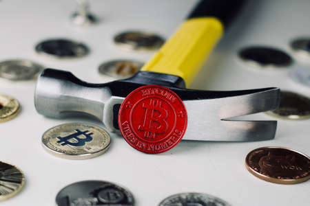 Digital currency physical metal bitcoin coin near steel hammer. Cryptocurrency conceptの写真素材