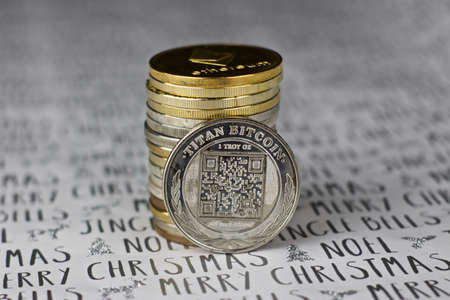 Digital currency physical metal bitcoin coin in christmas concept. White and grey background.の写真素材