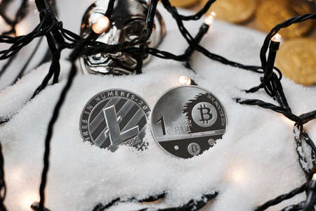 Digital currency physical metal bitcoin coin. Crypto currency christmas snow composition.の写真素材