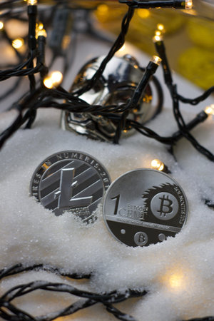 Digital currency physical metal bitcoin coin. Crypto currency christmas snow composition.