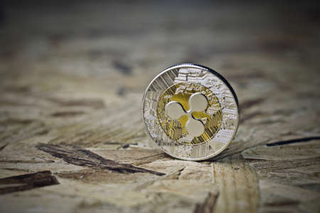 Digital currency physical metal silver ripple coin. Cryptocurrency wooden concept.の写真素材
