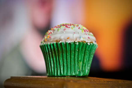 Delicious and fresh tasty cupcake in green paper with white chocolate.の写真素材