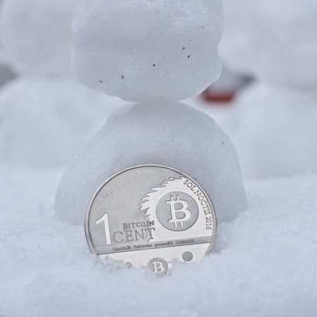 Digital currency physical metal bitcoin coin. Cryptocurrency snow bitcoin concept.の写真素材