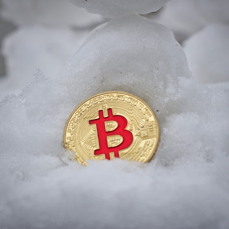 Digital currency physical metal bitcoin coin. Cryptocurrency snow bitcoin concept.の写真素材