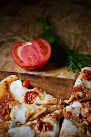 Fresh and delicious tomato pizza on the wooden table. Vegetarian pizza.の写真素材