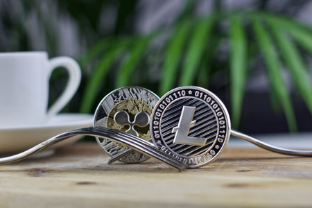 Digital currency physical metal litecoin coin. Cryptocurrency coffee concept.