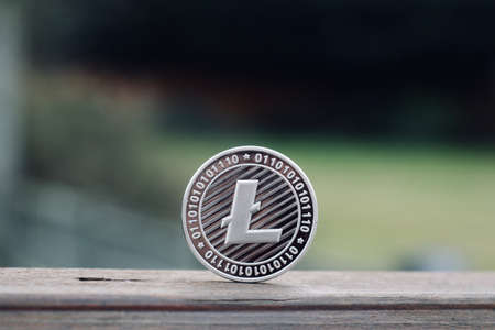 Digital currency physical metal litecoin coin. Cryptocurrency outdoor concept.の写真素材