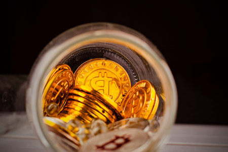 Digital currency physical metal bitcoin coin. Cryptocurrency savings concept.