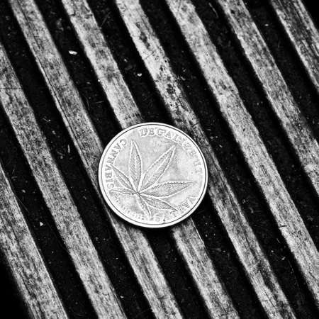 Physical metal brass marijuana coin. Cannabis coin concept.の写真素材