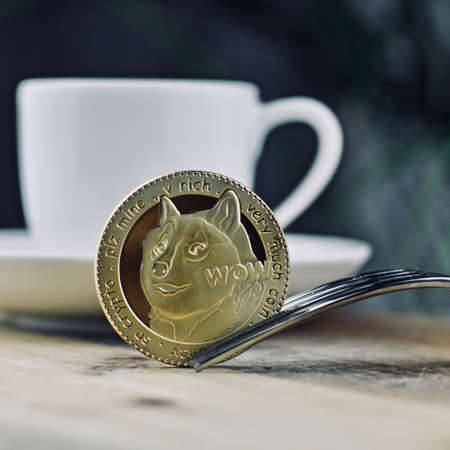 Digital currency physical metal gold dogecoin coin. Cryptocurrency business lunch.の写真素材