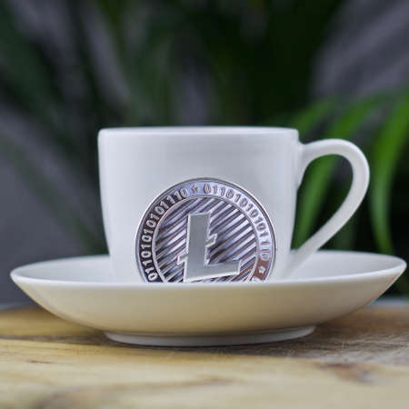 Digital currency physical metal litecoin coin. Cryptocurrency coffee concept.の写真素材
