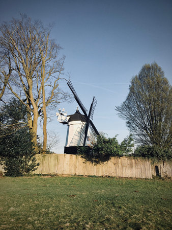 Old black and white wind mill on the farm. Countryside green concept.の写真素材