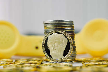 Digital currency physical metal bitcoin coin. Crypto currency phone concept.の写真素材