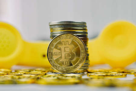 Digital currency physical metal bitcoin coin. Crypto currency phone concept.の写真素材