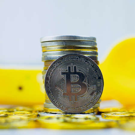 Digital currency physical metal bitcoin coin. Crypto currency phone concept.の写真素材