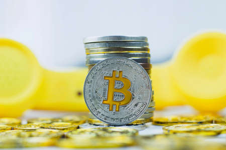 Digital currency physical metal bitcoin coin. Crypto currency phone concept.の写真素材