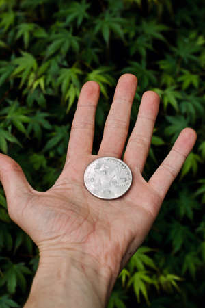 Digital currency physical metal monero coin. Cryptocurrency outdoor concept.の写真素材