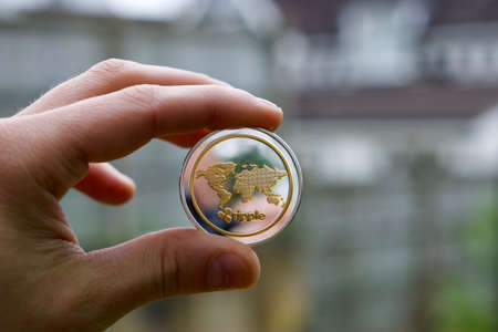 Digital currency physical metal ripple coin. Cryptocurrency outdoor concept.の写真素材