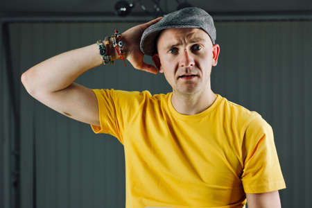 Bald young man in yellow tshirt. Tshirt mockup concept.の写真素材