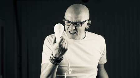 Bald young man in yellow tshirt. Tshirt mockup concept.の写真素材