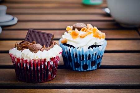 Tasty and fresh cupcakes on the wooden table. Sweet food concept.の写真素材