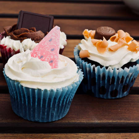 Tasty and fresh cupcakes on the wooden table. Sweet food concept.の写真素材