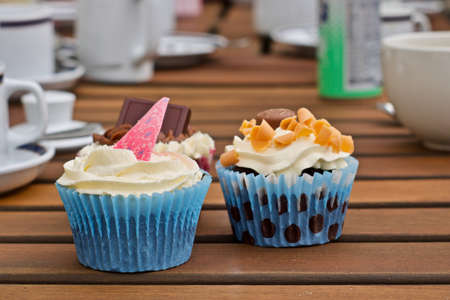 Tasty and fresh cupcakes on the wooden table. Sweet food concept.の写真素材