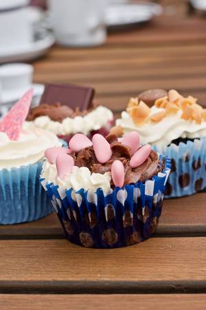 Tasty and fresh cupcakes on the wooden table. Sweet food concept.の写真素材