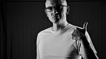 Bald young man in yellow tshirt. Tshirt mockup concept.の写真素材