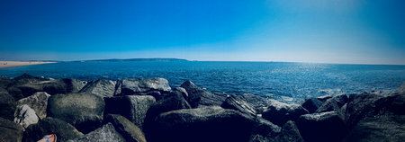 Ocean view landscape. Summer concept. Blue sky over the water. Big stones.