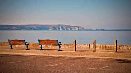 Summer concept. Two benches by the sea. View on the cliff.の写真素材