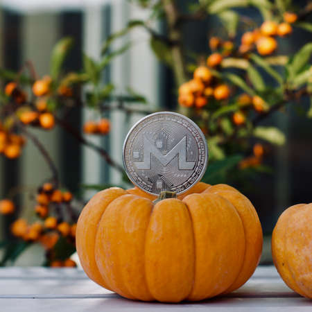 Digital currency physical metal monero coin. Cryptocurrency halloween concept.の写真素材