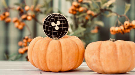 Digital currency physical metal ripple coin. Cryptocurrency halloween concept.の写真素材