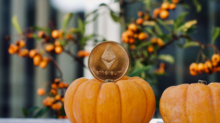 Digital currency physical metal ethereum coin. Halloween cryptocurrency concept.