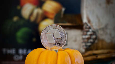 Digital currency physical silver metal neo coin. Orange halloween concept.のeditorial素材