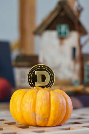 Digital currency physical metal gold dogecoin coin. Cryptocurrency halloween concept.の写真素材