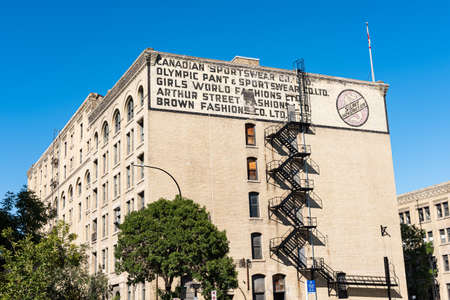 Old painted advertisements on old buildings of the center of the city of Winnipeg, Manitoba, Canada.のeditorial素材