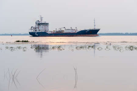 Nicolet, Quebec, Canada - 17 July 2021 - Seen from Anse-du-Port natural park, the Chemical / Oil tanker Nike of the K. Ships navigation company crossing the St Peter Lake by the Saint Lawrence Seawayのeditorial素材