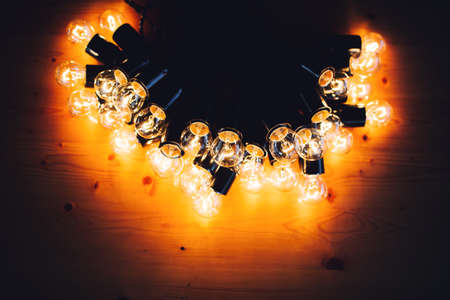 glowing bulb uniqueness concept on brown wooden tableの写真素材